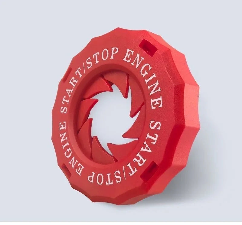 A red decorative ignition cover shaped like an engine start button.