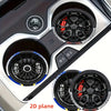 Close-up view of a silver car-shaped silicone coaster with a black racing wheel hub design.