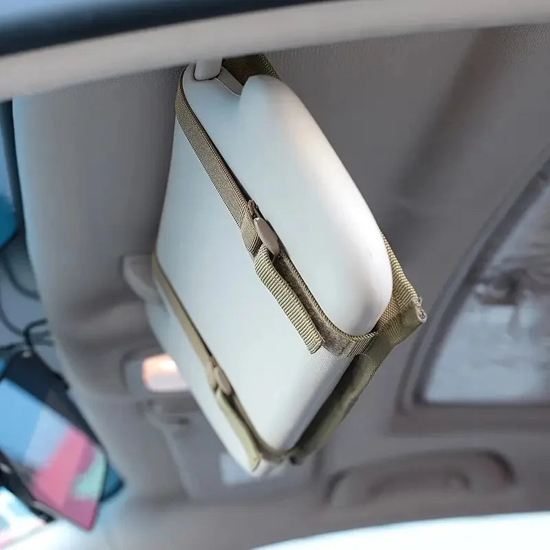 A white tactical visor organizer with a tan MOLLE pouch is shown hanging from a car ceiling.