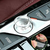 A close-up of a crystal clear ignition button protector installed on a car dashboard.