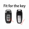 A black car key case cover with silver accents, showing the fit for a key.