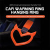 An orange heart-shaped car warning ring hanging ring accessory for automotive use.