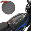 Close-up of a carbon fiber motorcycle mudguard and protection kit installed on a blue and black motorcycle.