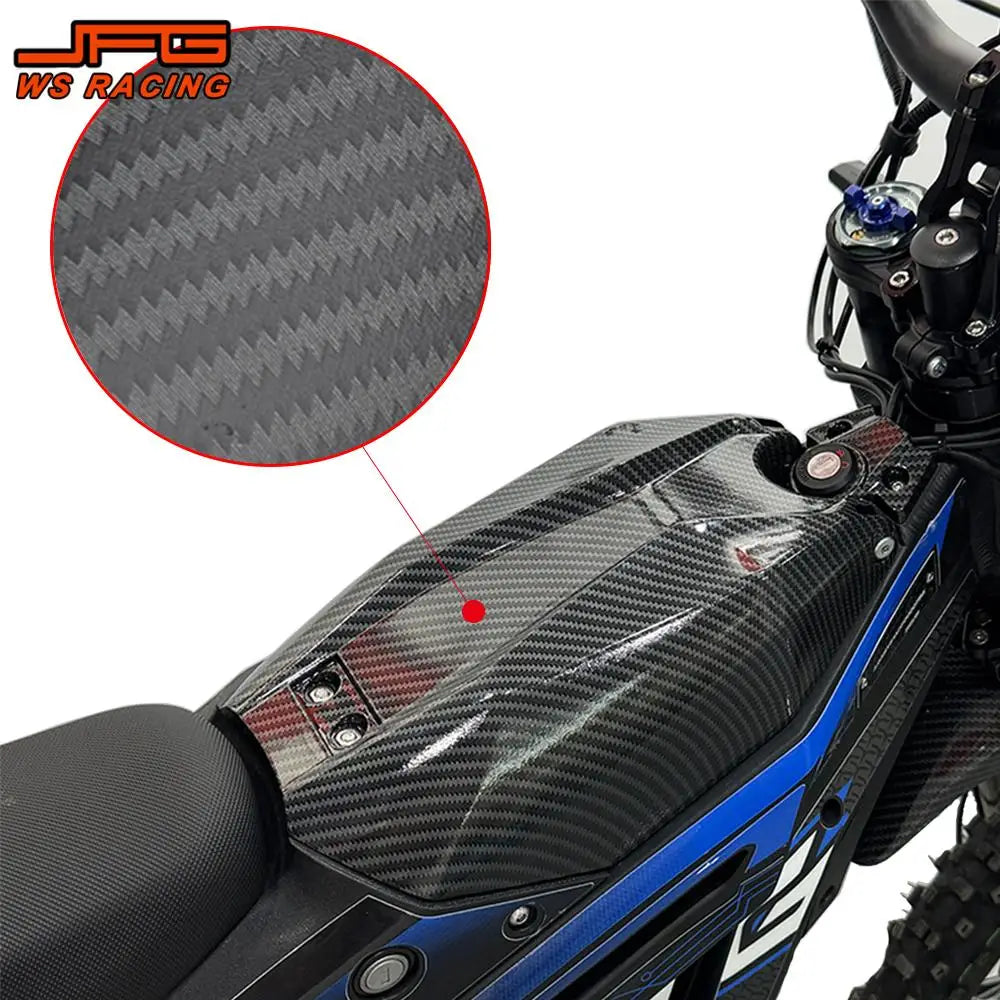 Close-up of a carbon fiber motorcycle mudguard and protection kit installed on a blue and black motorcycle.