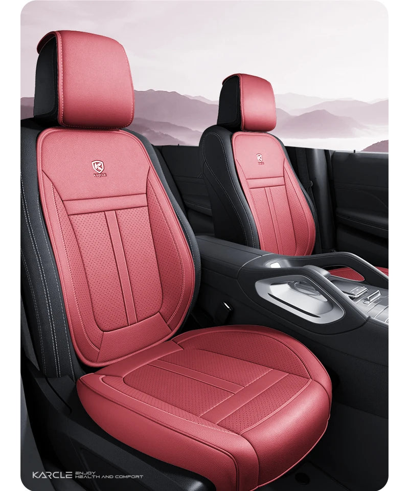 A close-up view of a red leather car seat cover with black accents in a vehicle interior.
