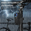 A black wireless bicycle alarm bracket installed on a bike frame, shown in rainy weather context.