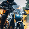A person riding a motorcycle with dynamic LED car eye lights illuminating the scene.