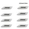 A set of black Bose 3D aluminum car audio emblems shown from the side.