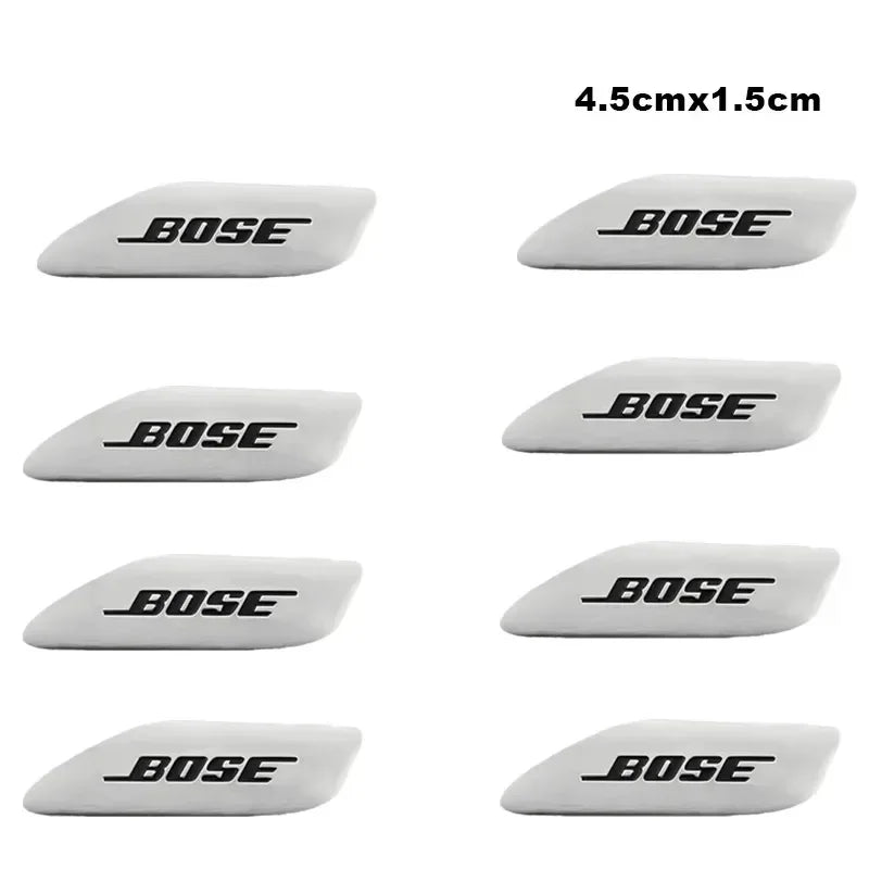 A set of black Bose 3D aluminum car audio emblems shown from the side.