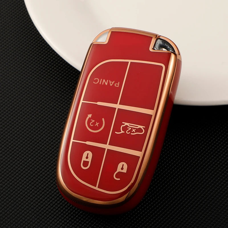A red TPU car key case cover with multiple buttons rests on a white dish.