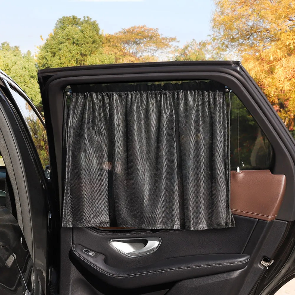 A black suction cup window sunshade is shown inside an open car door.