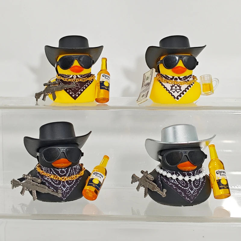 Two yellow rubber duck car ornaments with black hats and sunglasses, displayed on a clear shelf.