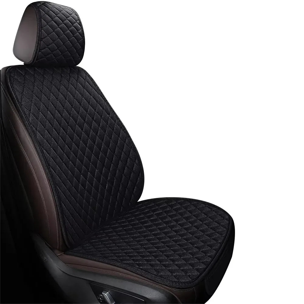 A close-up view of a black universal breathable car seat and floor mat.