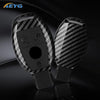 A pair of carbon fiber car key covers for Mercedes models displayed on a dark surface.