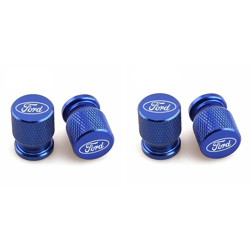 Four blue aluminum Ford car wheel valve caps shown in various angles