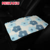 A light blue and white floral plush cushion designed for a car armrest.