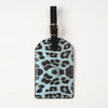 Black leather passport holder with a leopard print design and gold-toned hardware.