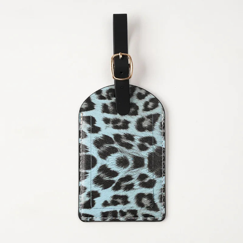Black leather passport holder with a leopard print design and gold-toned hardware.