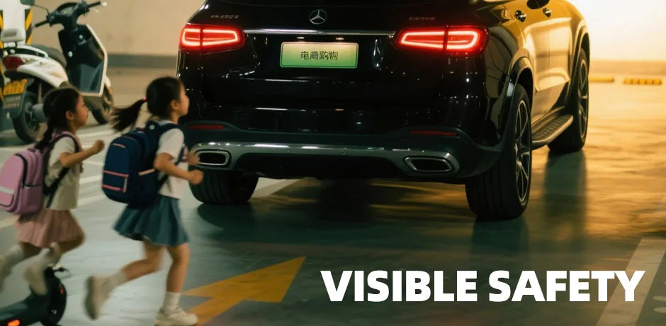 A dark SUV with a visible safety camera mounted on the rear, being approached by children.