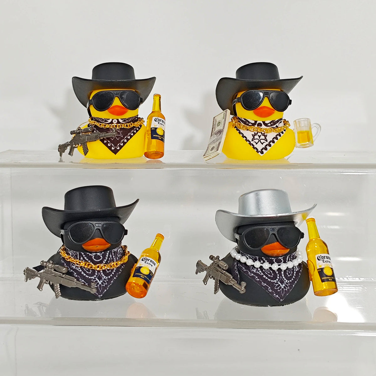 A set of funny rubber duck car ornaments featuring a duck face and a sombrero, displayed on a clear shelf.
