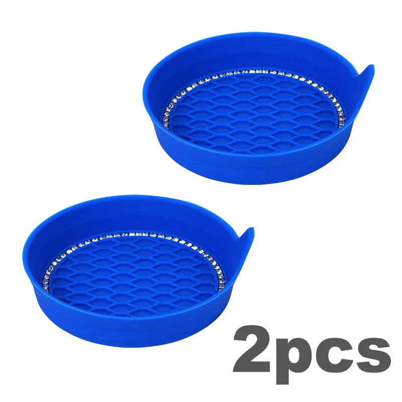 Two blue plastic rhinestone car cup holder coasters with a diamond pattern.