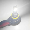 A close-up view of a universal LED headlight and fog lamp bulb assembly with a bright white light.