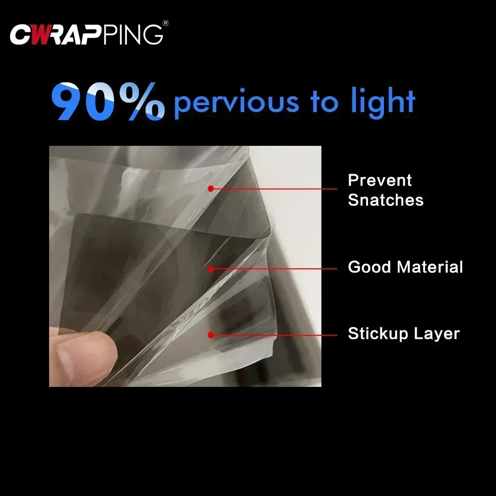 Close-up view of a clear tint film being applied to a car headlight, demonstrating its perviousness to light.