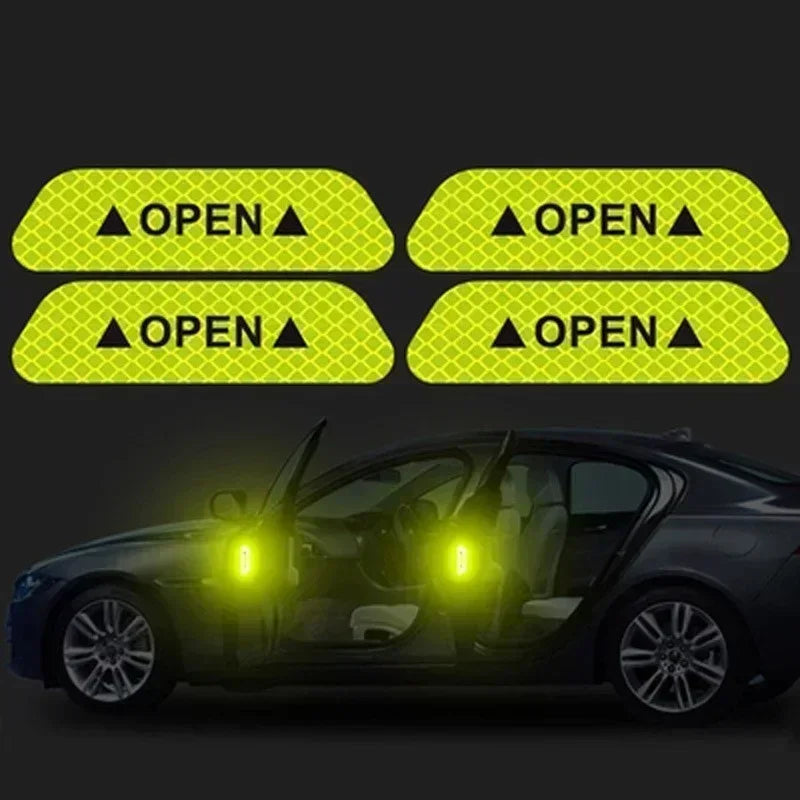 Four yellow reflective decals showing open door warnings on a dark car.