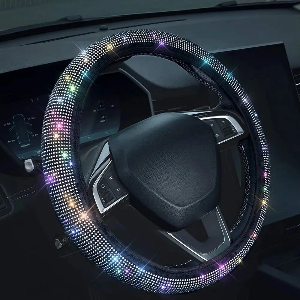A close-up of a steering wheel covered in sparkling rhinestones and LED lights.