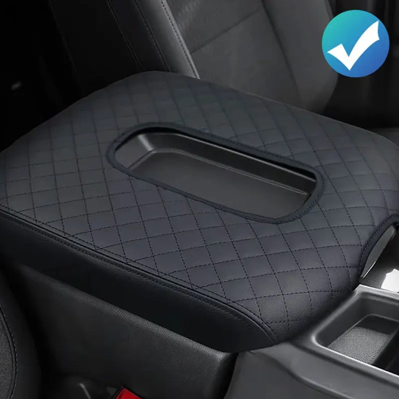 Black luxury microfiber armrest pad installed in a vehicle interior.