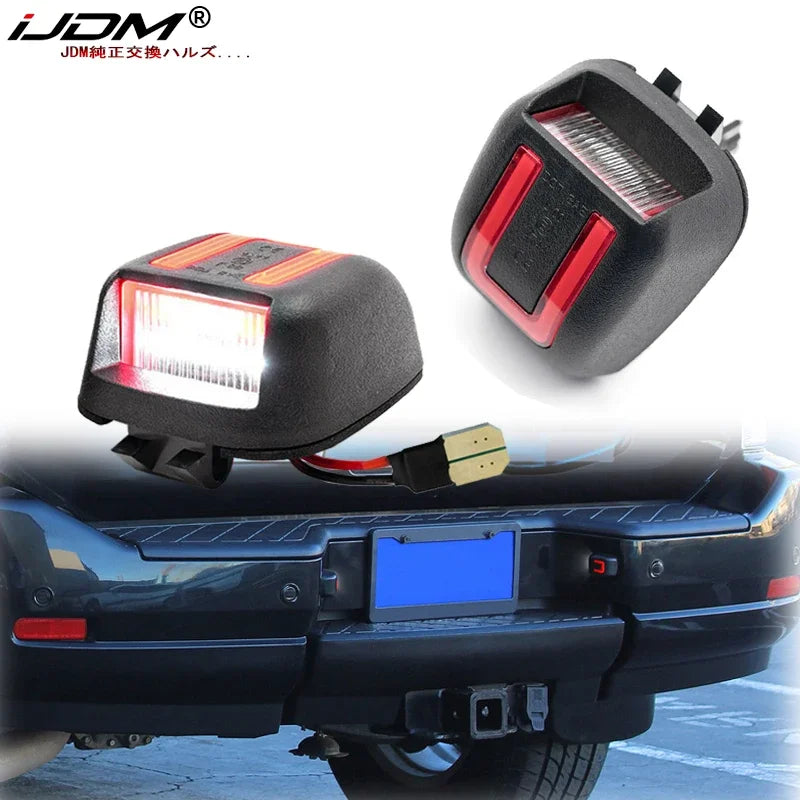 LED license plate lights installed on a black vehicle bumper.