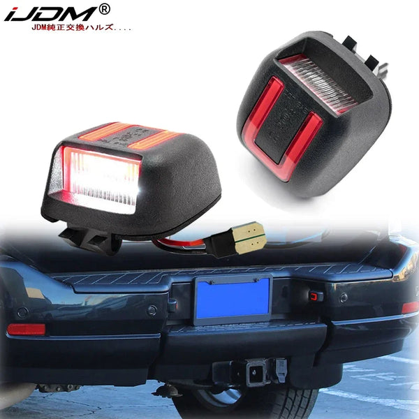 LED license plate lights installed on a black vehicle bumper.