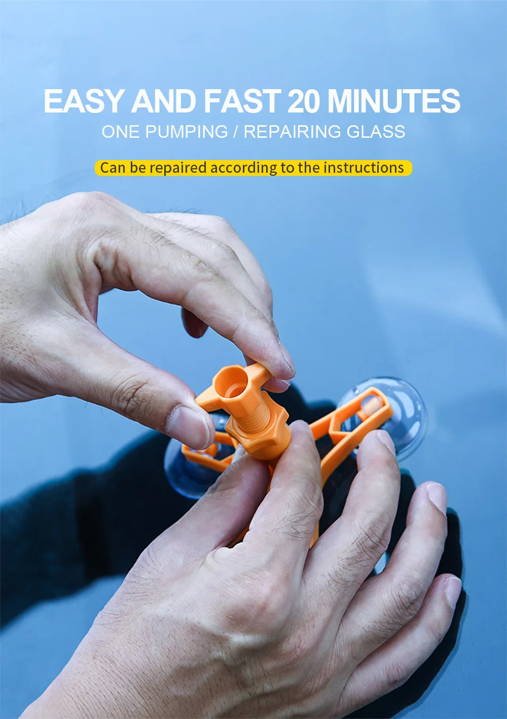 A hand is using an orange tool to repair a cracked glass on a car windshield.