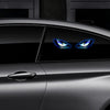 Close-up of a dark car with glowing blue demon eye lights visible on the side panel.
