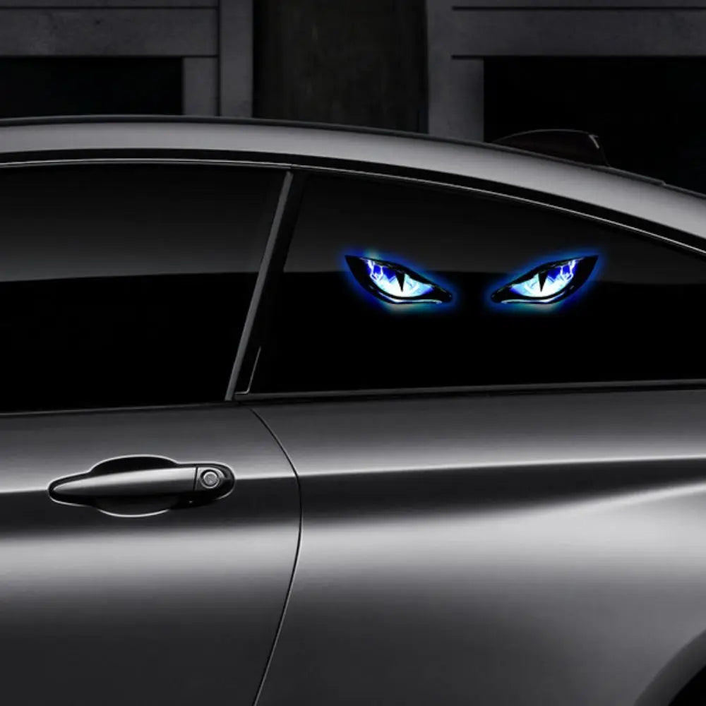 Close-up of a dark car with glowing blue demon eye lights visible on the side panel.