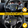 A black steering wheel trim cover is shown being fitted onto a vehicle's steering wheel, with an indicator showing it does no