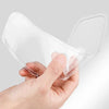 A hand is holding a clear anti-fog and rain-repellent film for a motorcycle helmet visor.