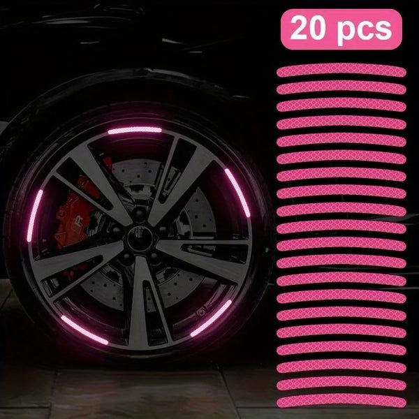 Un juego de 20 decoraciones reflectantes de neumáticos y ruedas rosas para coche, exhibidas contra un fondo oscuro.