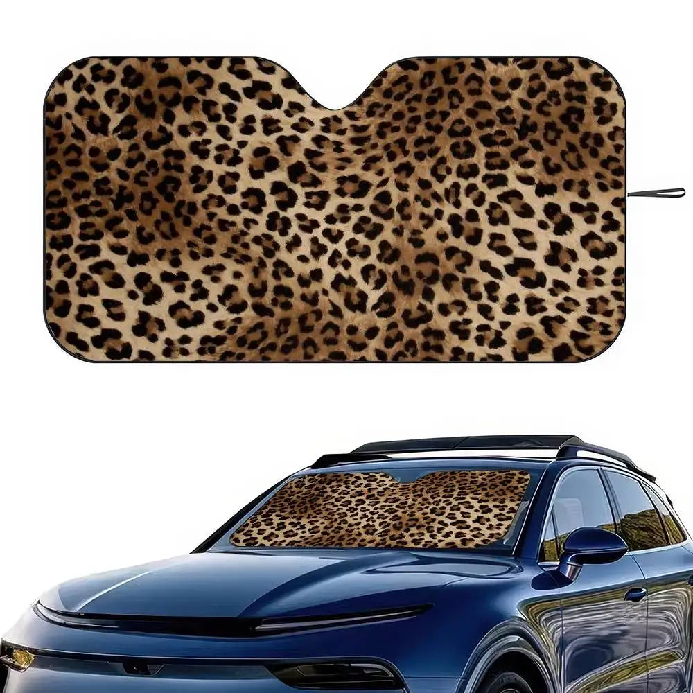 A leopard print car sunshade applied to the window of a blue car.