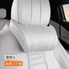 White memory foam car headrest with a leather cover shown in the back seat of a vehicle.