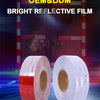 Rolls of bright reflective film for OEM and ODM use displayed in front of a red door background