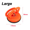 Orange car dent glass suction removal tool with a large handle and base.