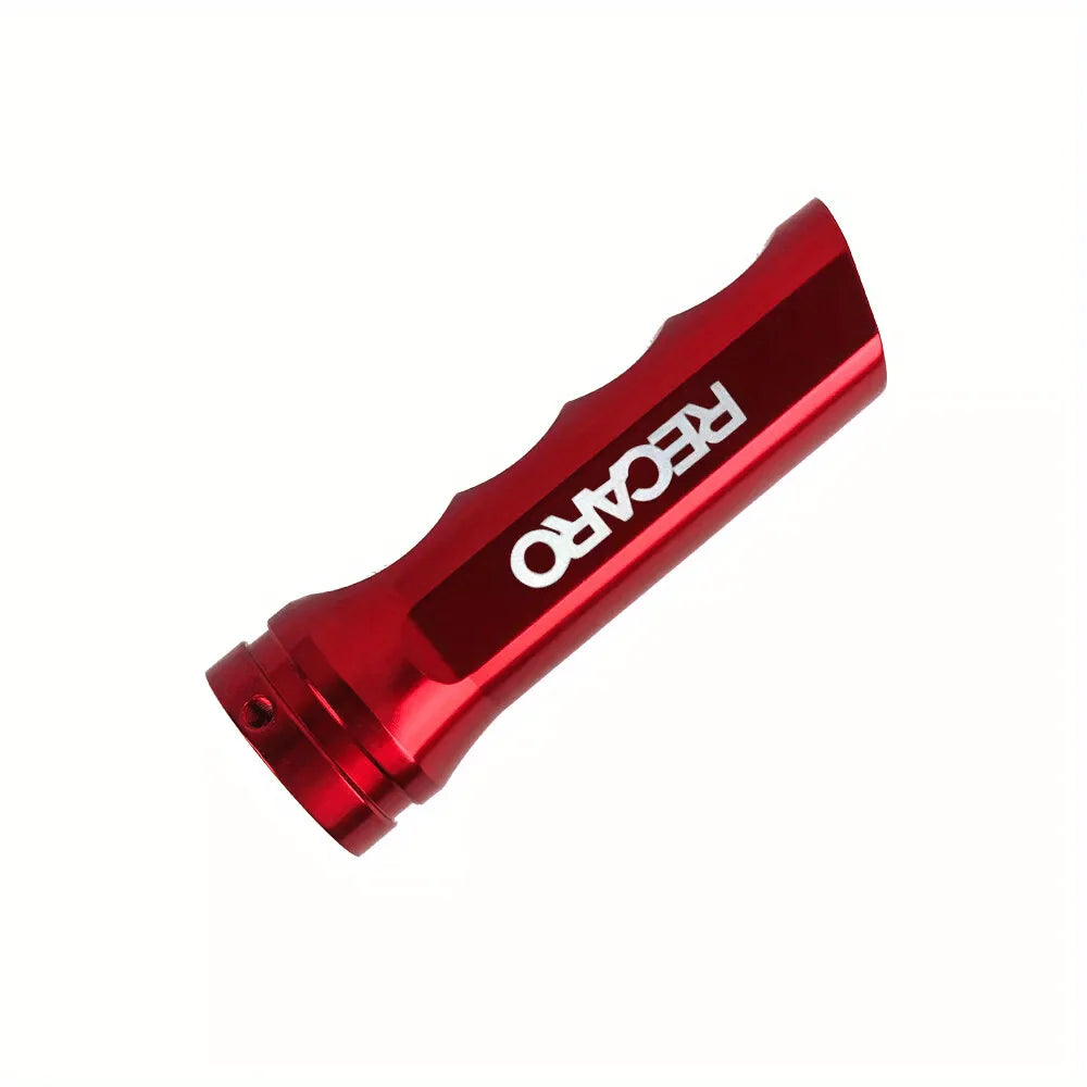 A red aluminum handbrake cover for a manual transmission.