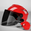 A red half helmet with a clear visor is shown on a gray background.