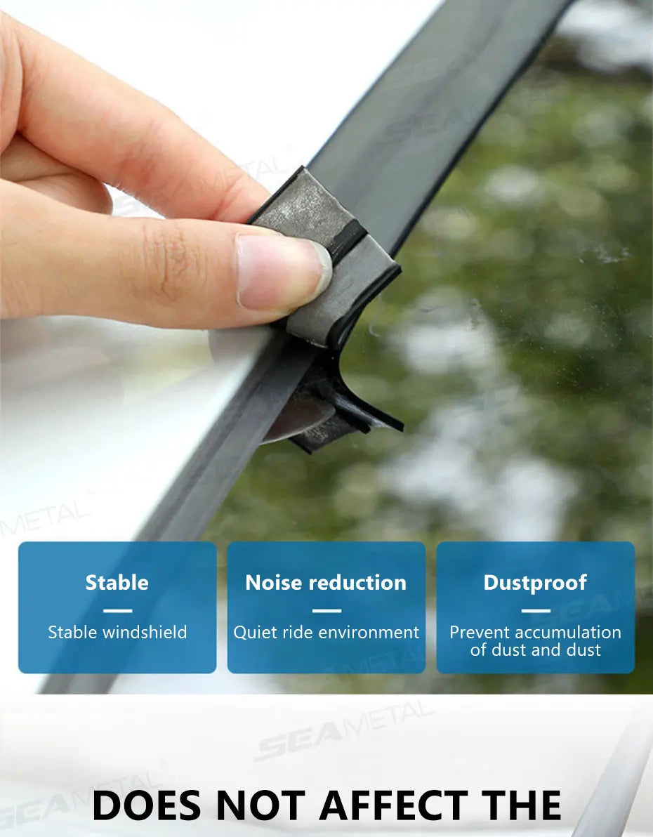 A hand is installing a durable metal weather strip for sealing a car windshield.