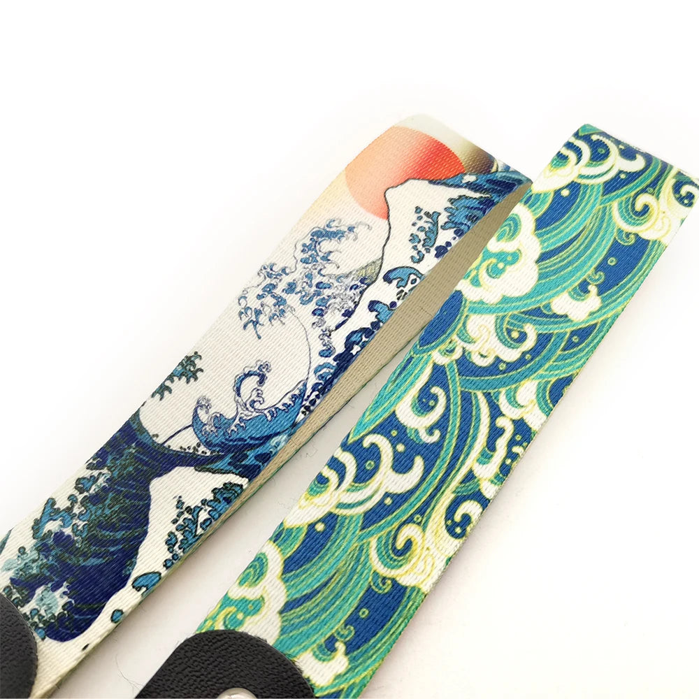 A close-up of a JDM car keychain lanyard featuring a blue and green wave pattern on a light background.