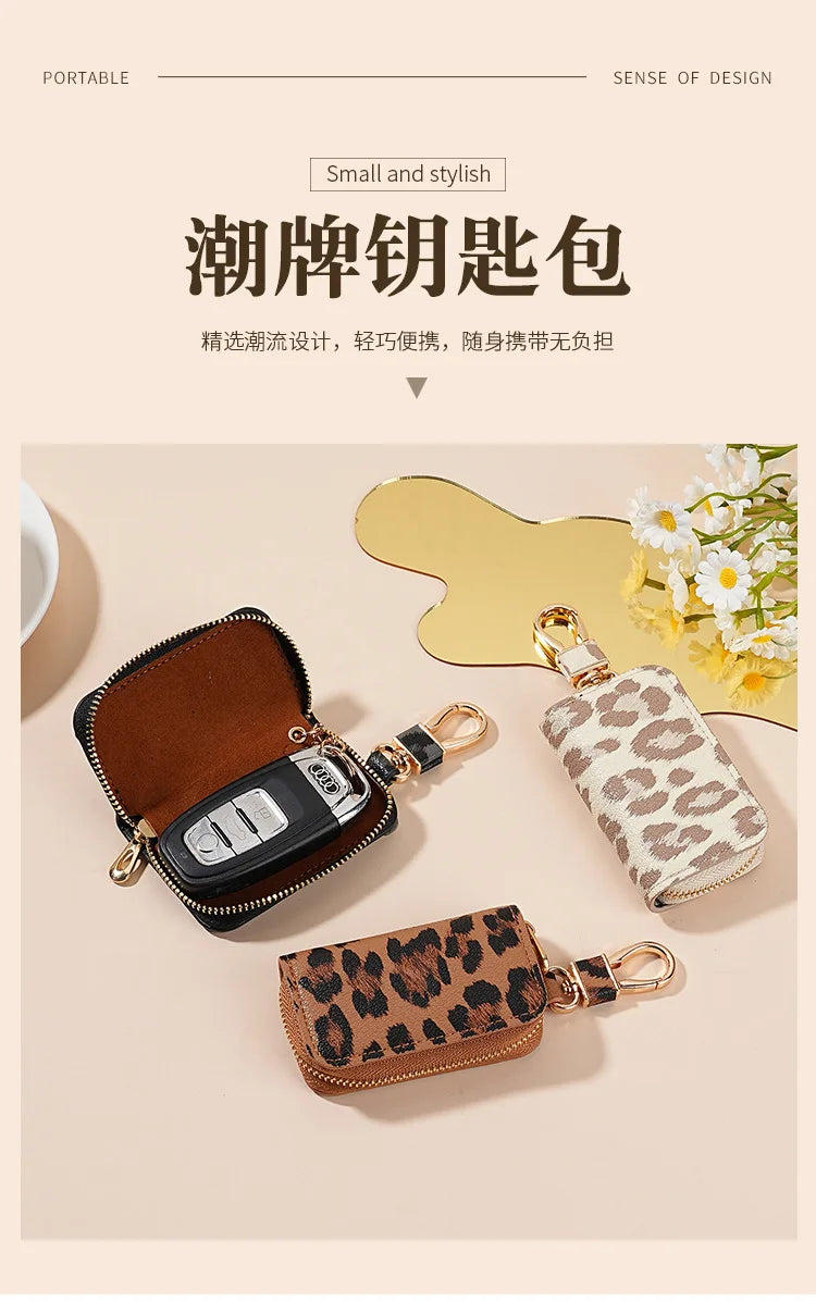 A collection of small, stylish leopard print car key holders and a leather pouch displayed on a light background.