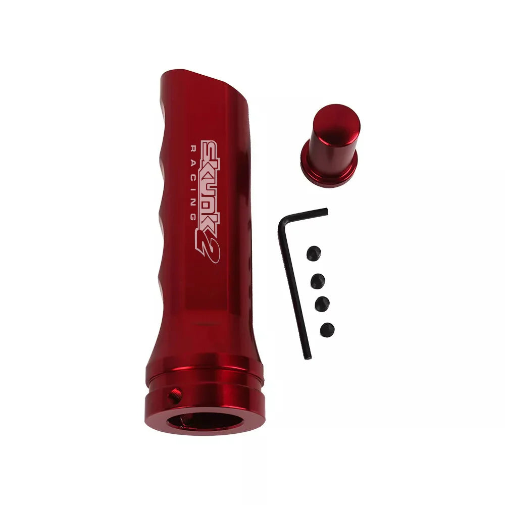 A red aluminum handbrake cover for a manual transmission with an attached pin and mounting bracket.