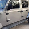 Close-up of a silver door hinge cover trim for a Jeep Wrangler or Gladiator.