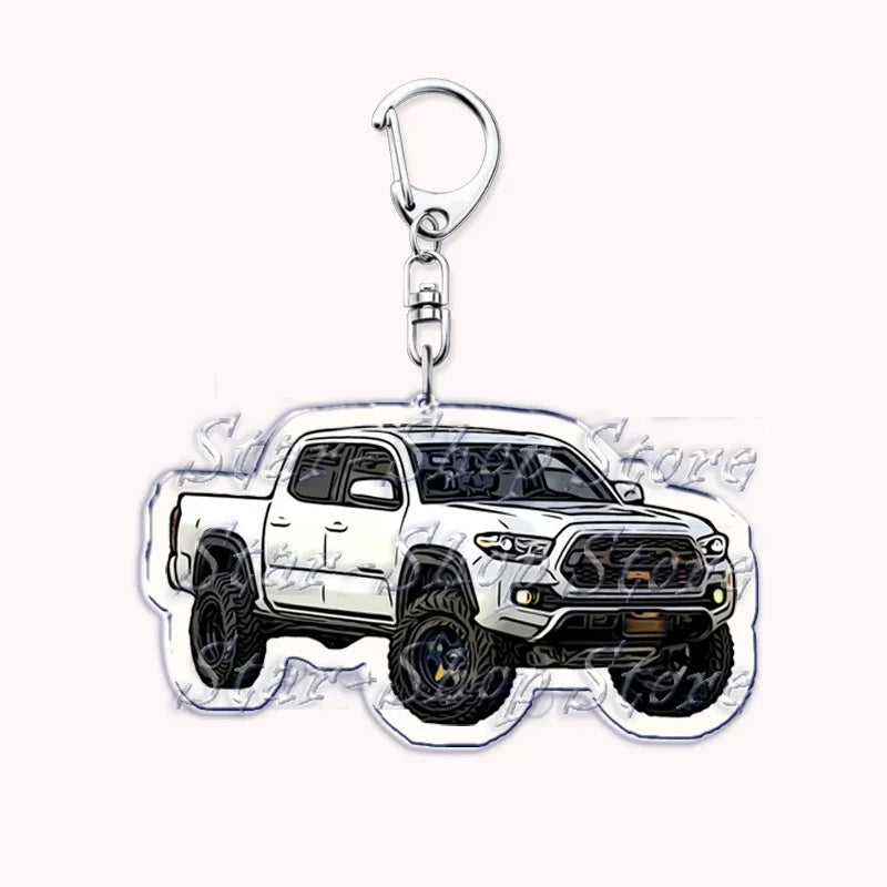 Silver acrylic keychain featuring a white off-road truck model.